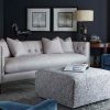 A living room with a couch and ottoman in it