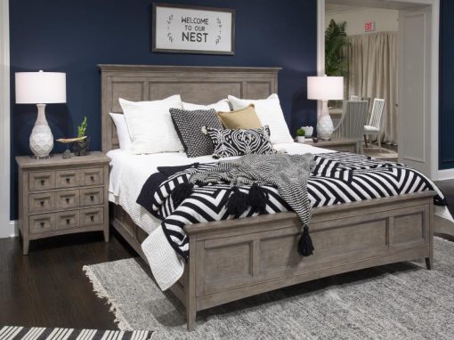 A bedroom with blue walls and white bedding.