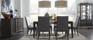 A dining room table with chairs and lamps