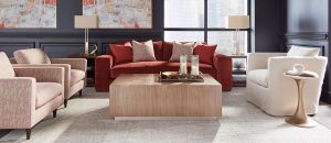 A red couch and coffee table in front of windows.