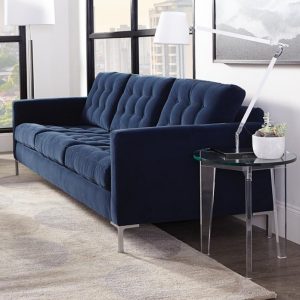 A blue couch in the middle of a room