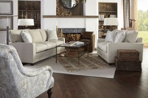 A living room with two couches and a fireplace.